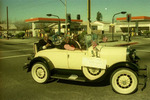 Car with flags and handwritten sign by Henry Hooks
